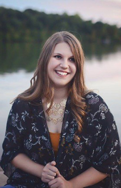 photo of Annabelle Darby sitting by a lake 